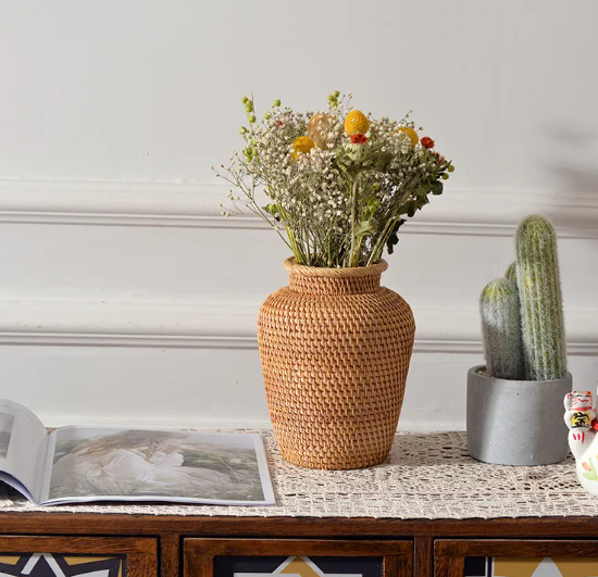 Small handwoven rattan basket on a wooden base