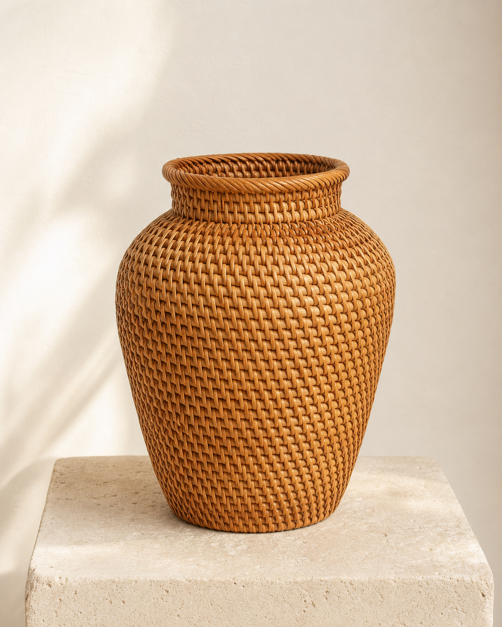 Handwoven rattan vase on a stone plinth