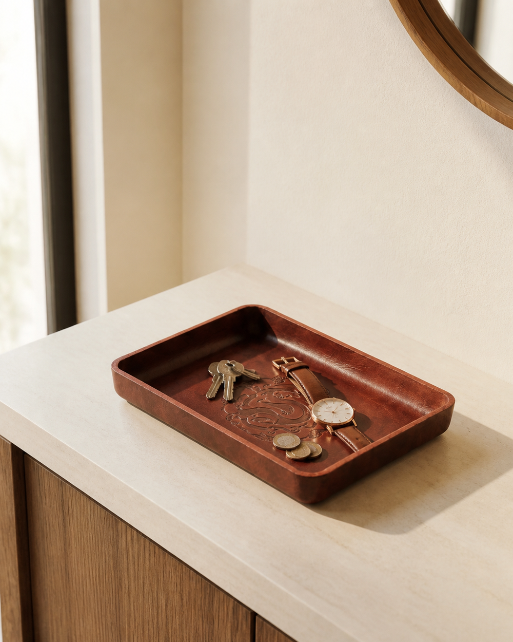 Leather tray holding keys, a watch, and coins